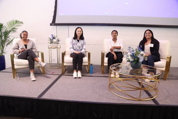 A group of people sitting on a stage

Description automatically generated